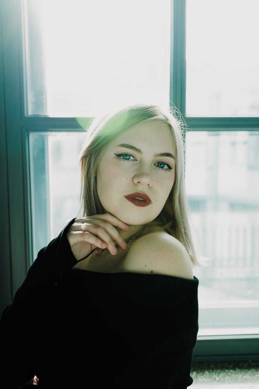 elegant portrait of a young woman by window